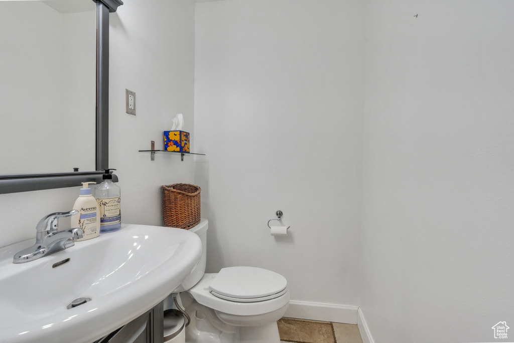 Half bath featuring a sink and tile patterned flooring