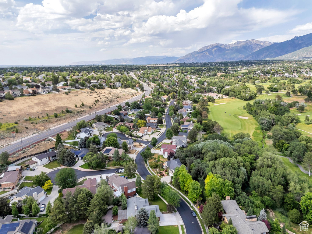 Aerial view of residential area with mountains and a golf club