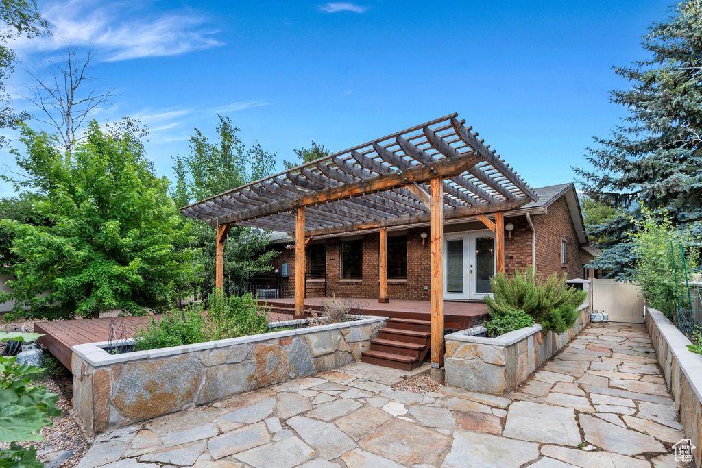 View of patio / terrace featuring french doors and a pergola