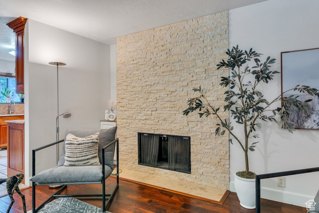 Living area featuring wood finished floors and a fireplace