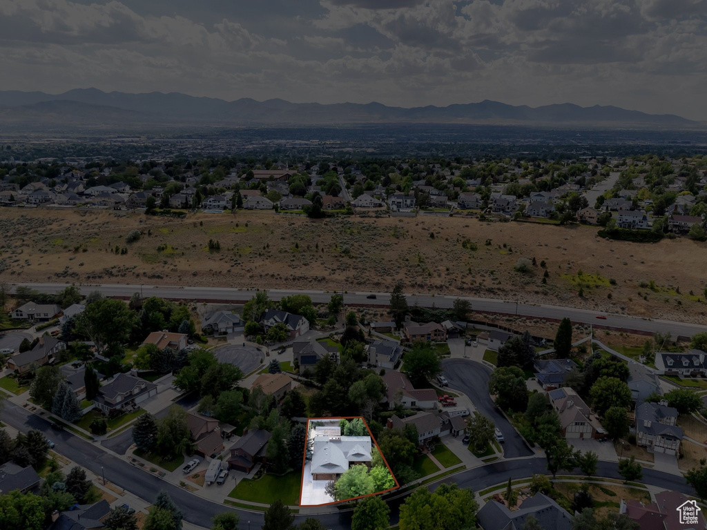 Aerial view of residential area with mountains and property parcel outlined