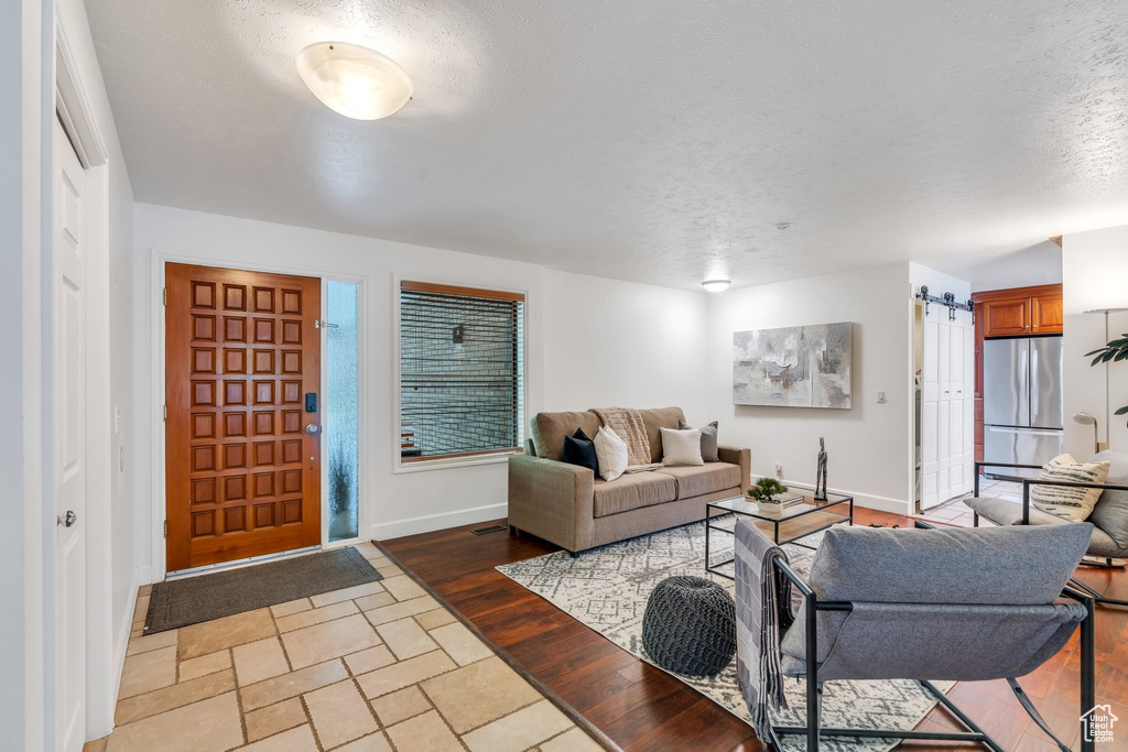 Living area with a textured ceiling and baseboards