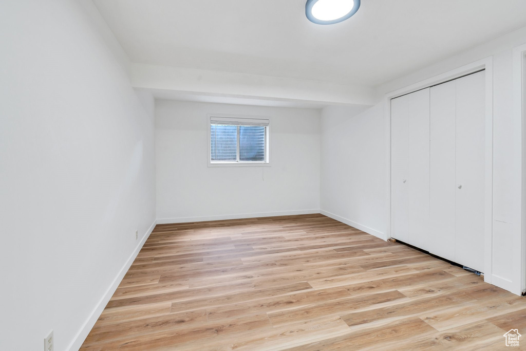 Unfurnished bedroom featuring light wood-style flooring and a closet