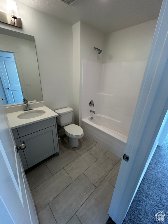 Bathroom featuring vanity and washtub / shower combination