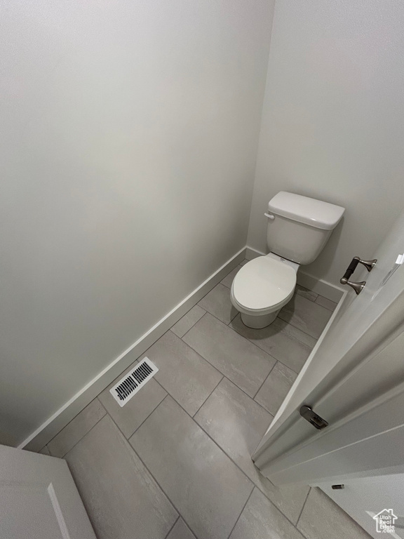 Bathroom featuring toilet and baseboards