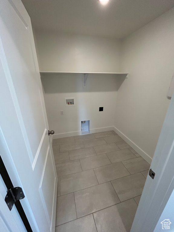 Washroom with washer hookup, electric dryer hookup, and light tile patterned floors