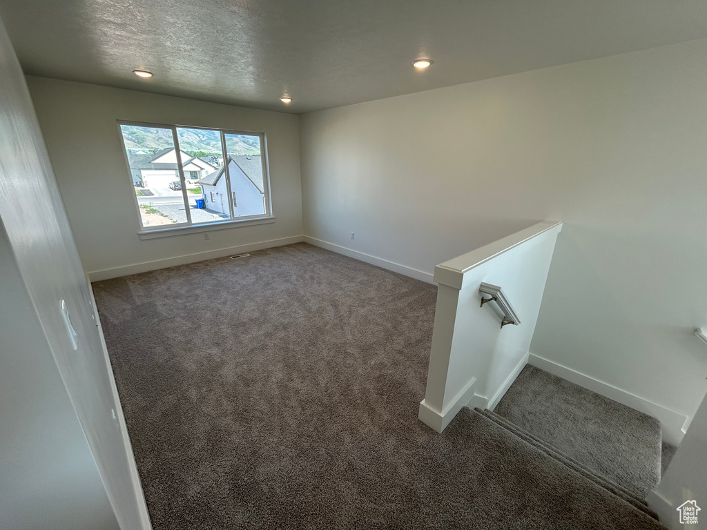 Carpeted spare room with recessed lighting