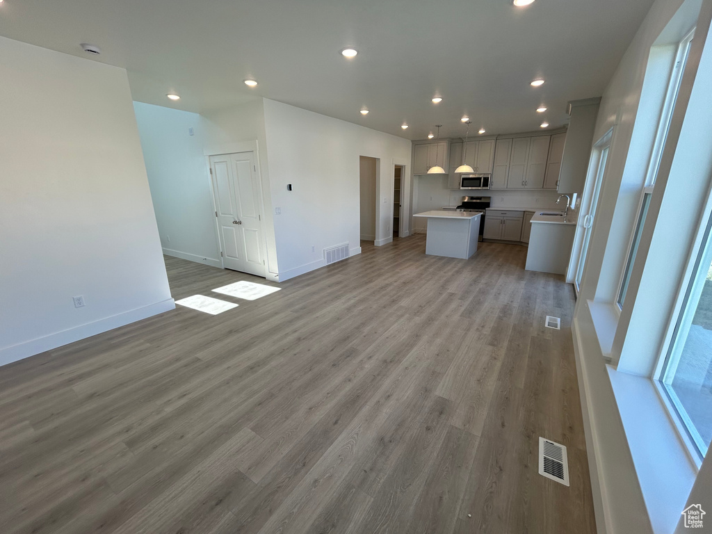 Unfurnished living room with light wood-style flooring and recessed lighting