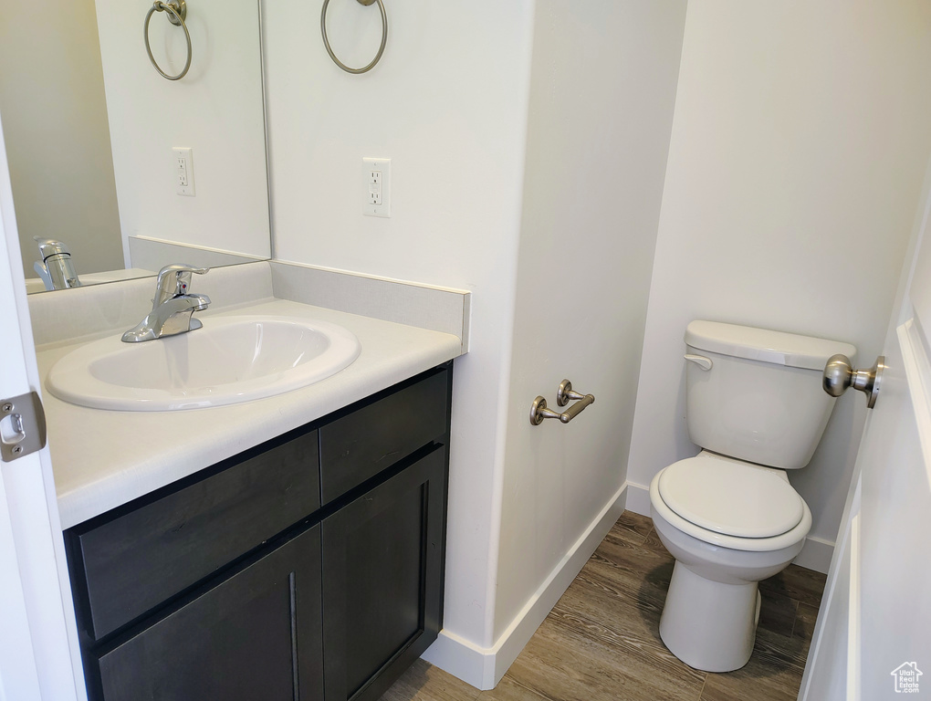 Bathroom featuring vanity and wood finished floors