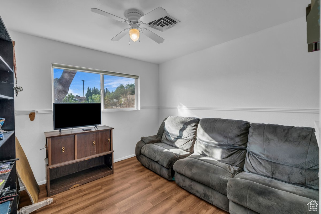 Living area featuring a ceiling fan and wood finished floors