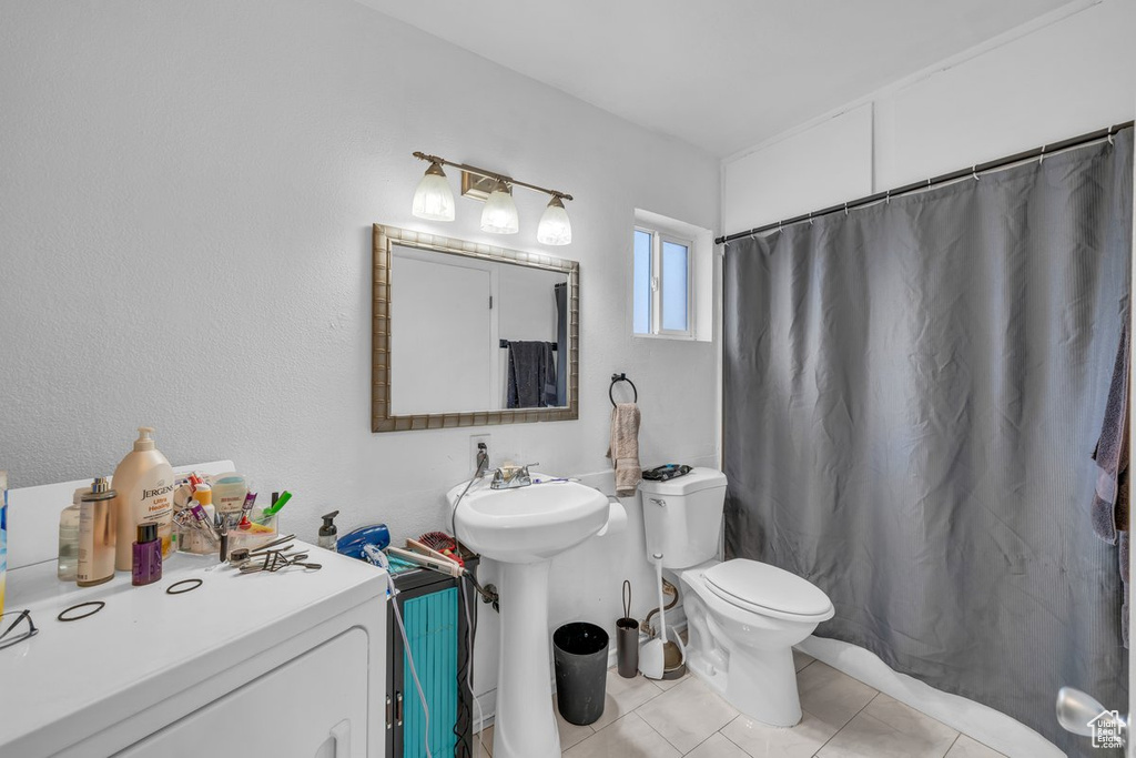 Full bathroom featuring tile patterned flooring and a shower with curtain
