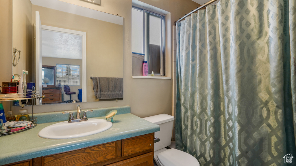 Bathroom featuring vanity, curtained shower, and connected bathroom