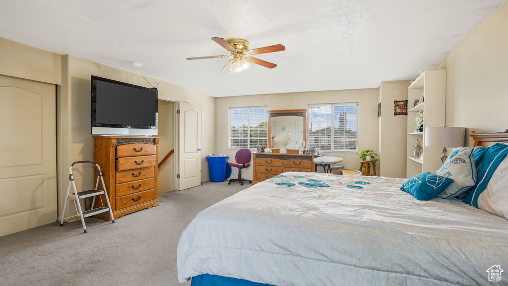 Bedroom featuring light carpet and a ceiling fan