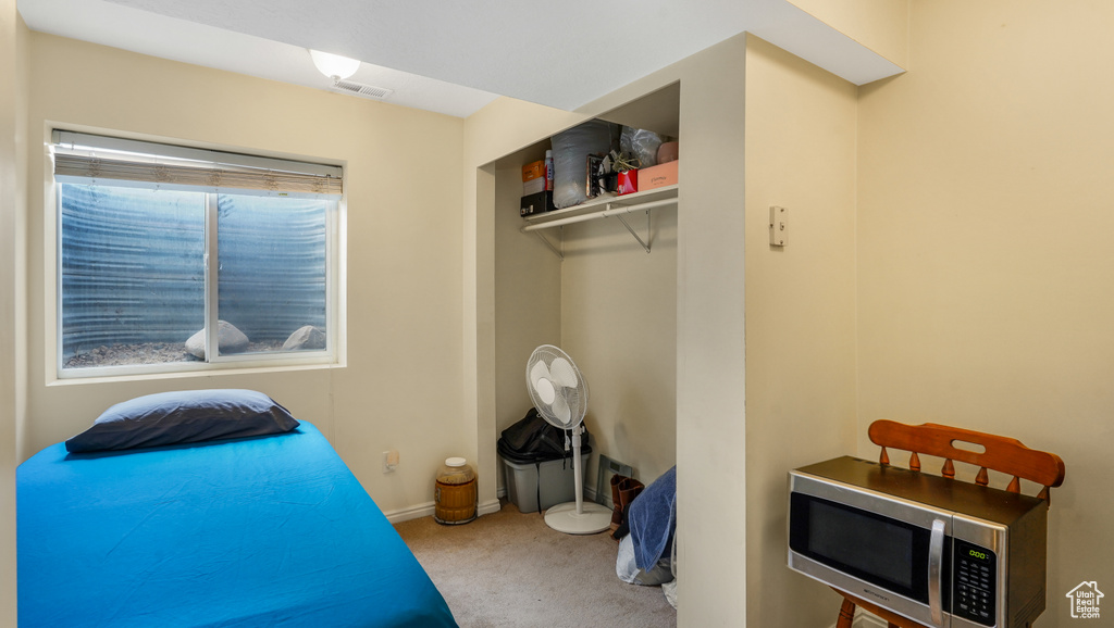 Bedroom with carpet flooring and baseboards