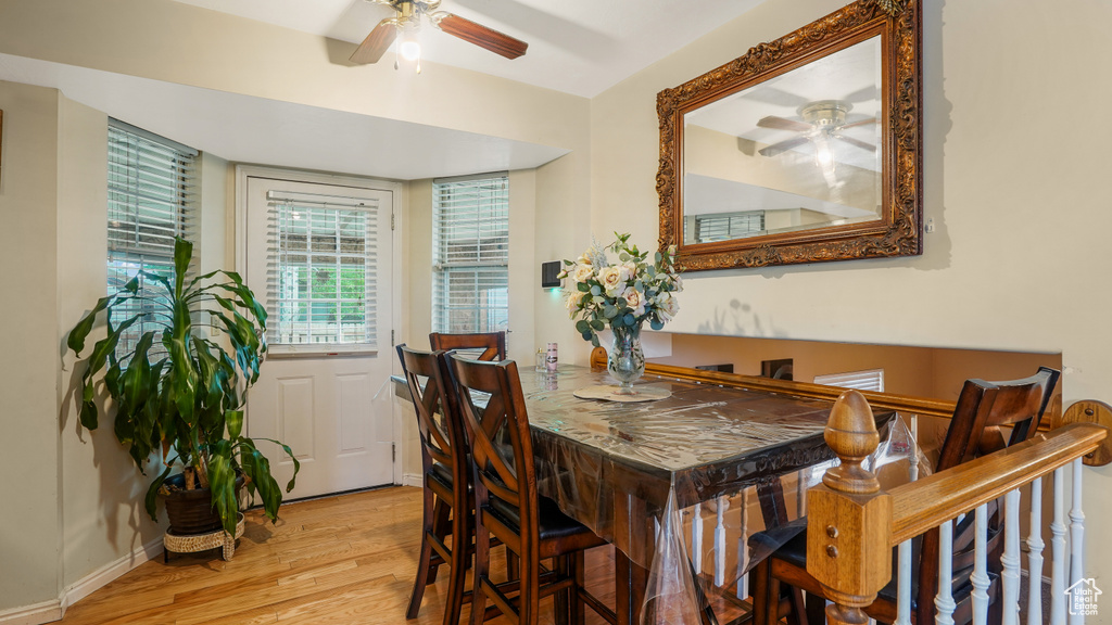 Dining area with a ceiling fan and wood finished floors