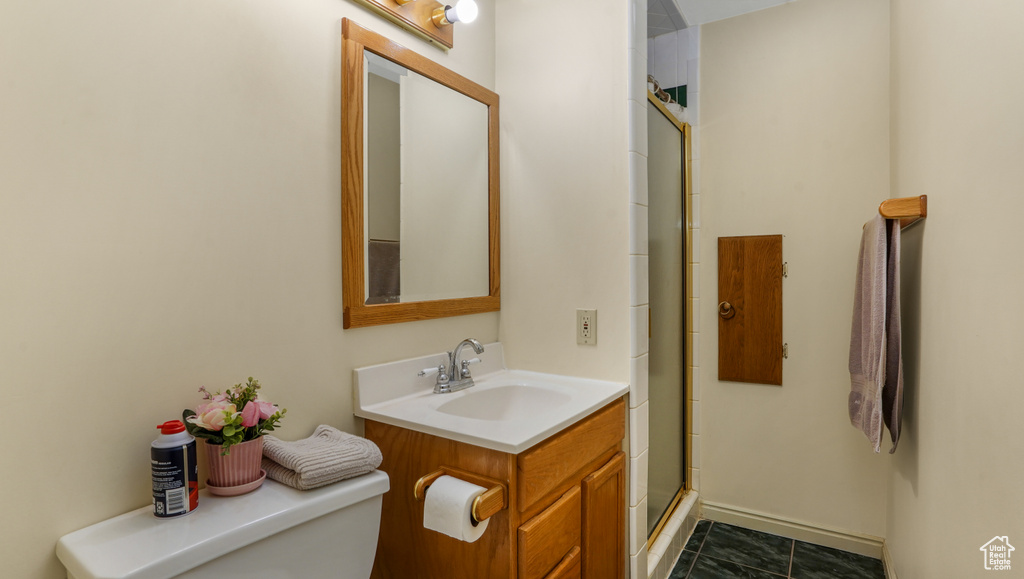 Full bath featuring vanity and an enclosed shower