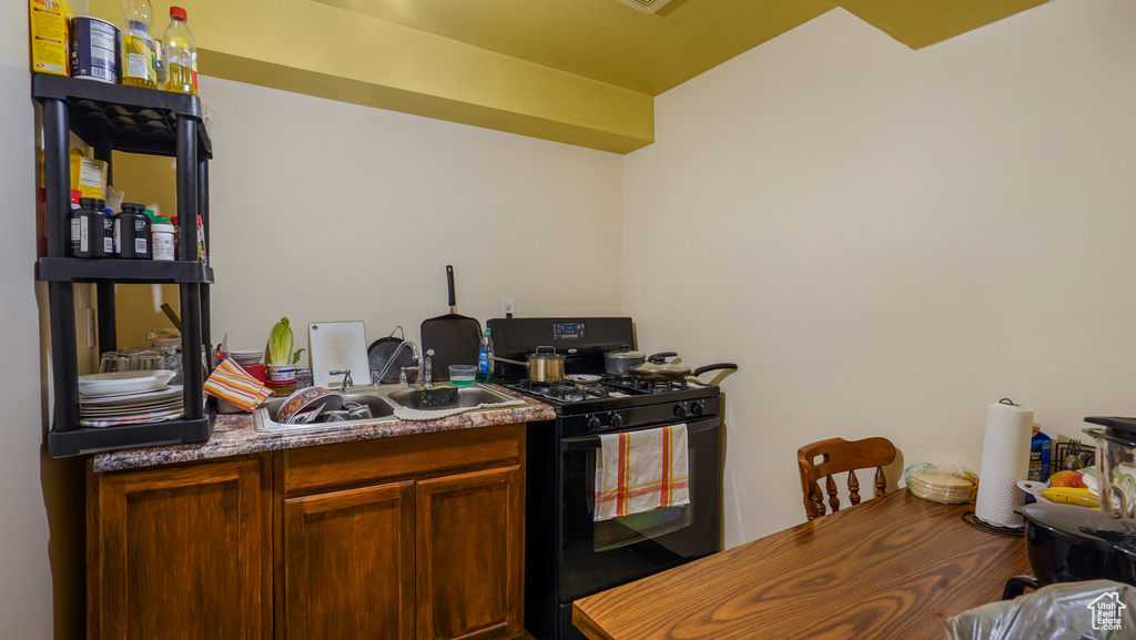 Kitchen with gas stove and a sink