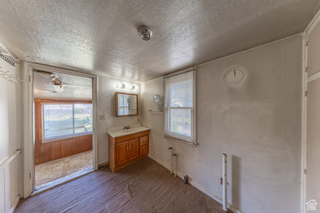 Bathroom featuring a textured ceiling and vanity