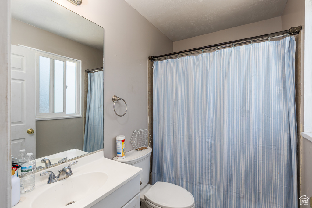 Bathroom with vanity and curtained shower