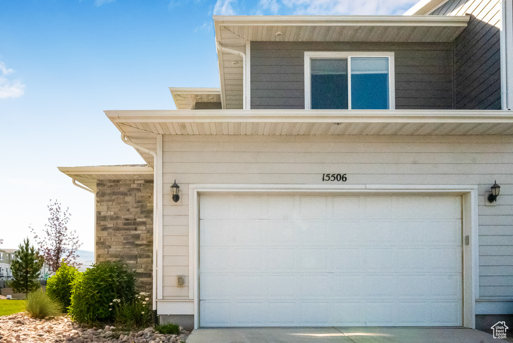 Garage featuring concrete driveway