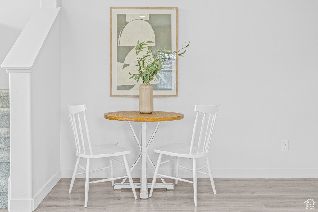 Dining area with wood finished floors and baseboards