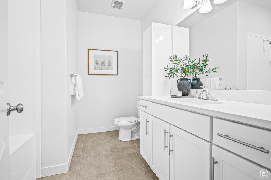 Bathroom with vanity and tile patterned flooring