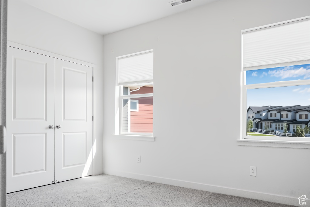 Unfurnished bedroom featuring a closet and baseboards
