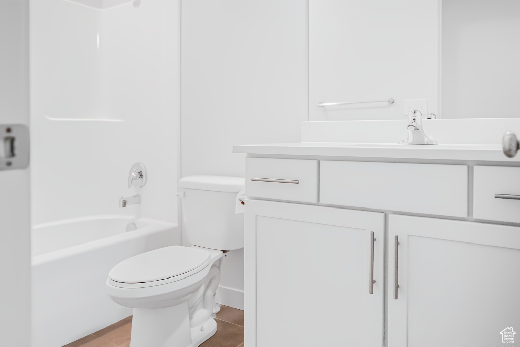 Bathroom with vanity, toilet, and  shower combination