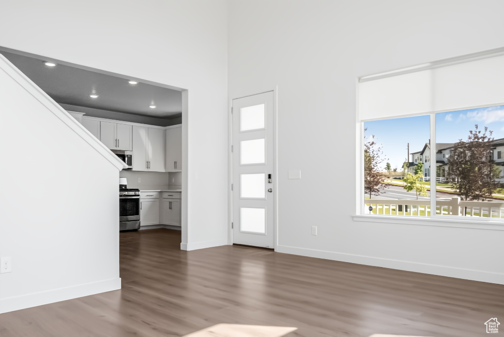 Entrance foyer with dark wood finished floors, baseboards, and recessed lighting