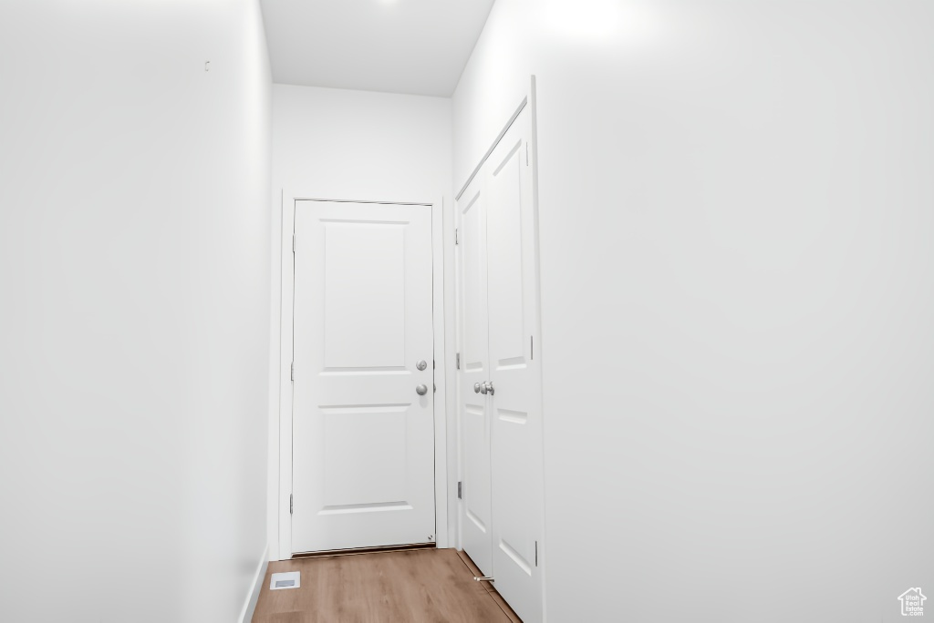 Hall featuring light wood-style flooring