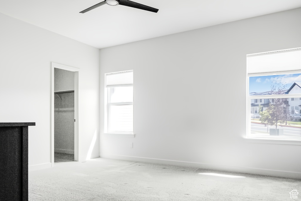 Unfurnished bedroom featuring multiple windows, carpet, and baseboards