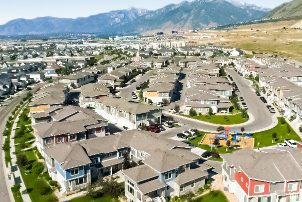 Aerial overview of property's location featuring a mountain backdrop and nearby suburban area