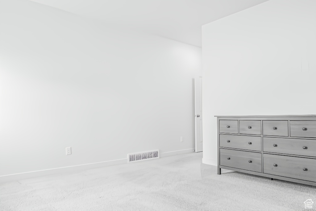 Bedroom featuring light carpet and baseboards