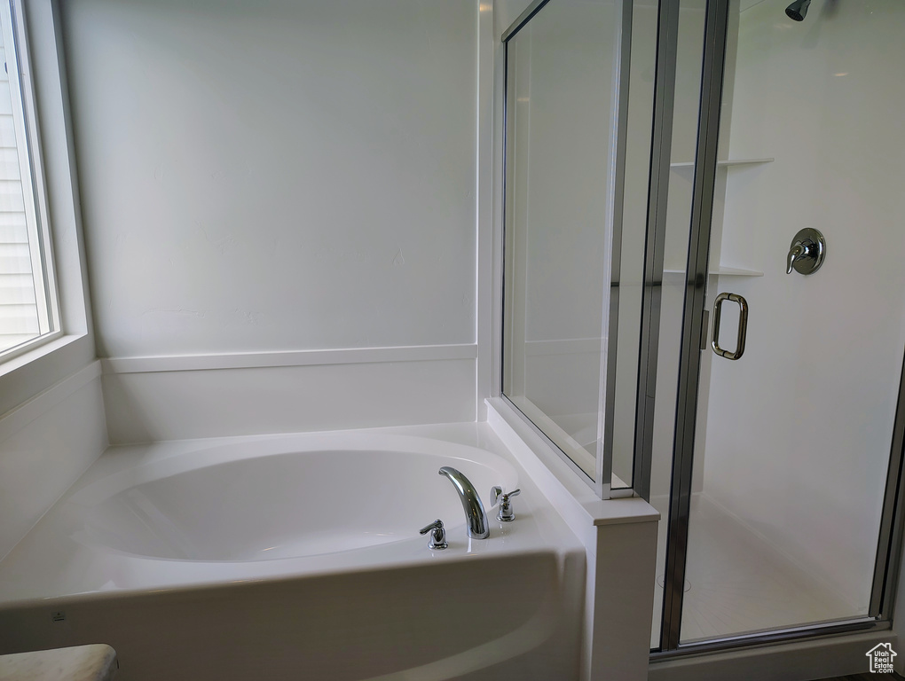 Bathroom with a stall shower and a garden tub