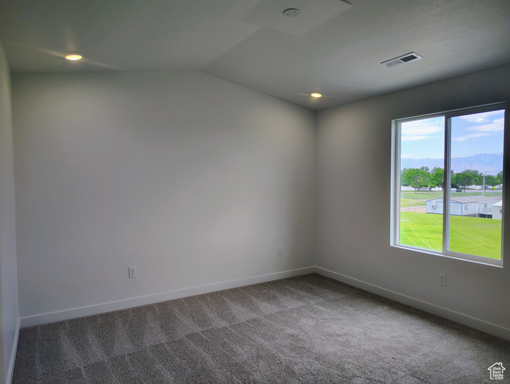 Spare room featuring carpet, lofted ceiling, and recessed lighting
