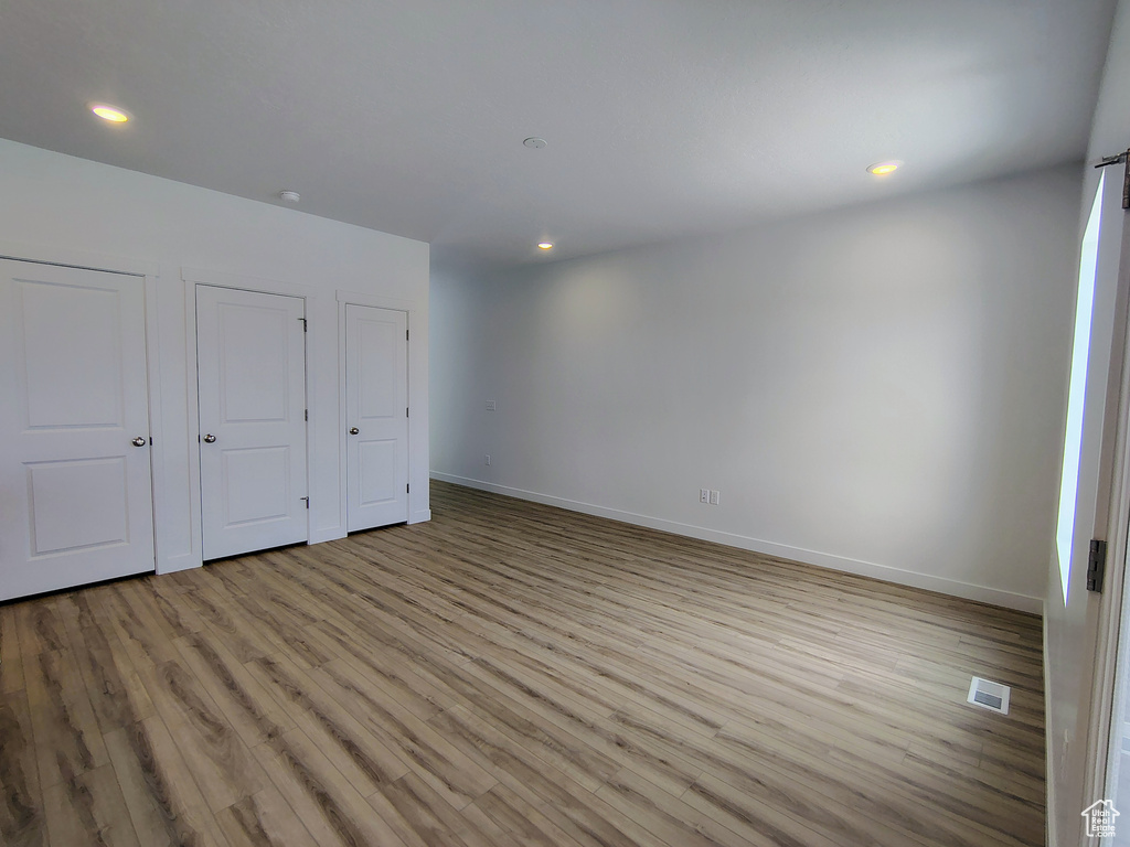 Unfurnished bedroom featuring light wood-type flooring and recessed lighting
