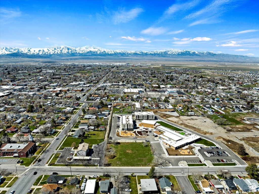 Aerial view of property's location featuring a mountain backdrop and nearby suburban area