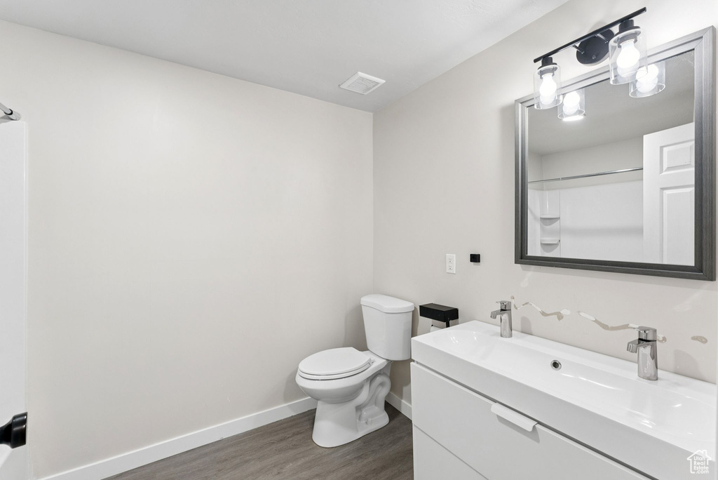 Full bath featuring wood finished floors and vanity