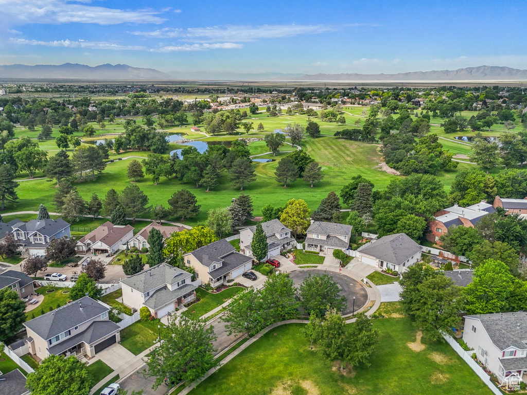 Aerial view of residential area featuring a water and mountain view and a golf course