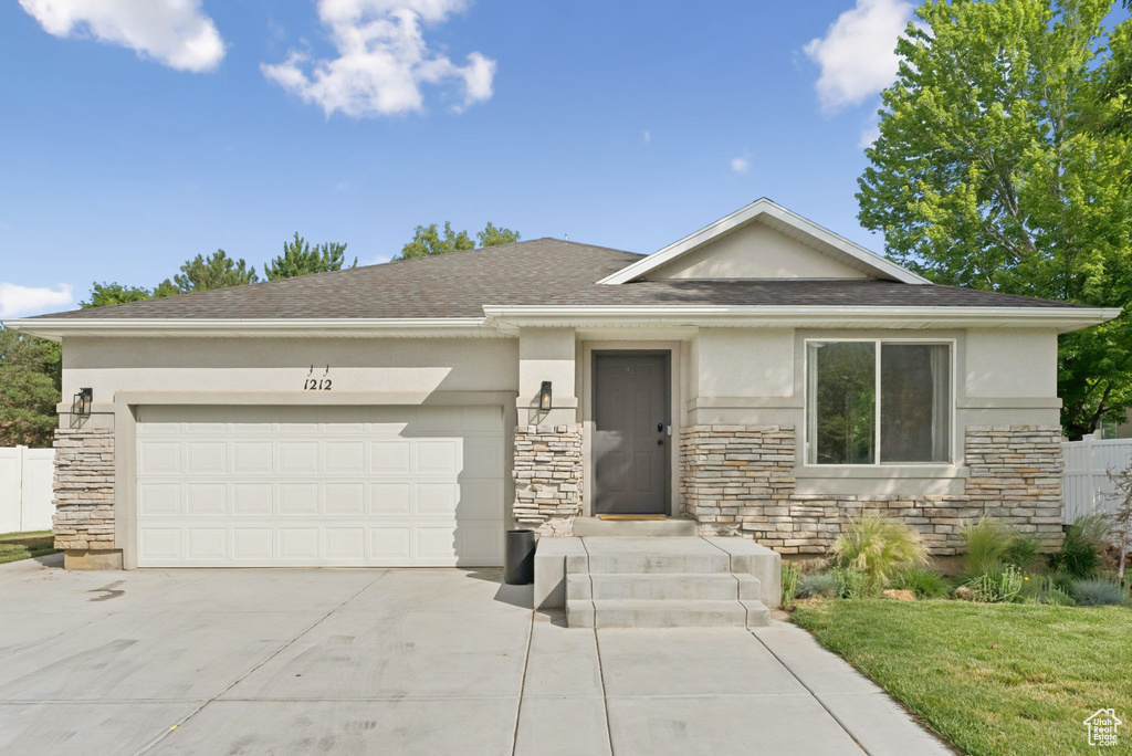 View of front facade with stone siding and stucco siding