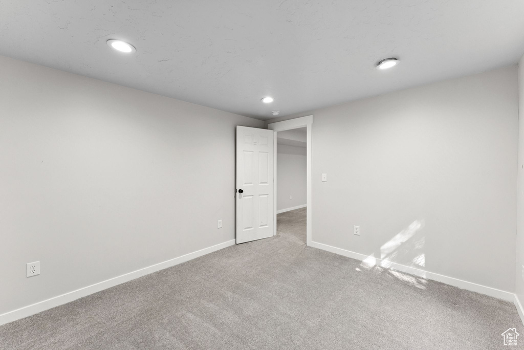 Unfurnished bedroom with carpet floors and recessed lighting