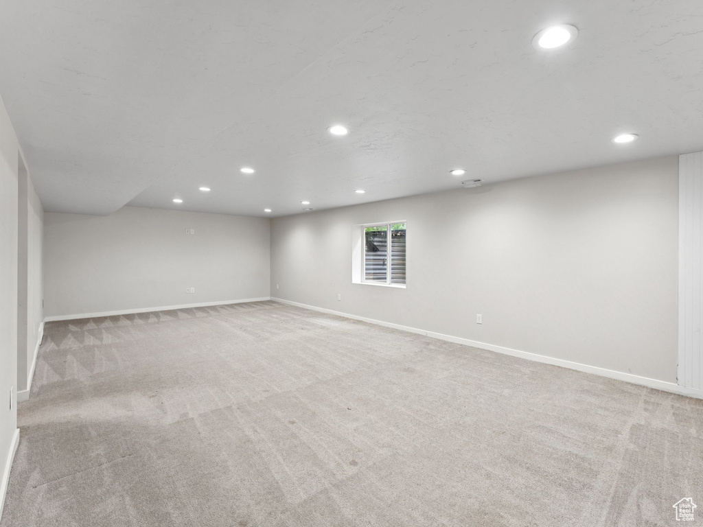 Finished below grade area featuring recessed lighting and carpet