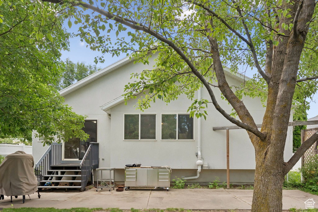 Rear view of house featuring stucco siding and a patio