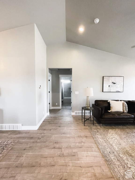 Living area featuring lofted ceiling and light wood-style flooring