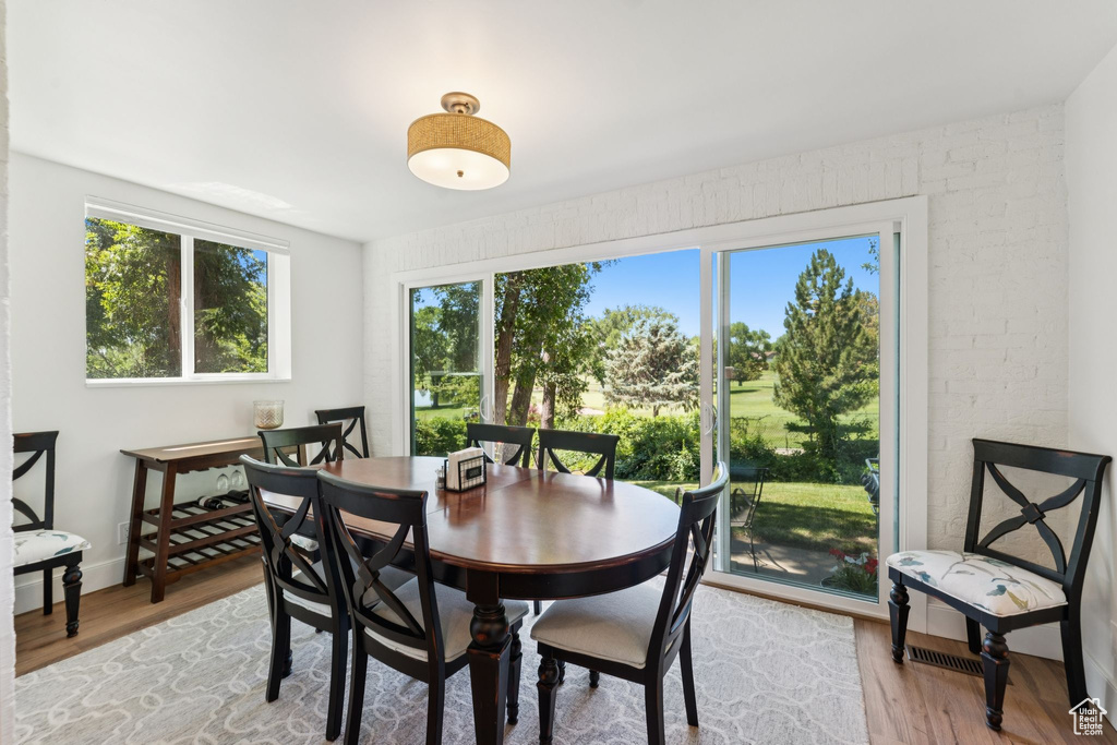 Dining area with plenty of natural light and light wood finished floors