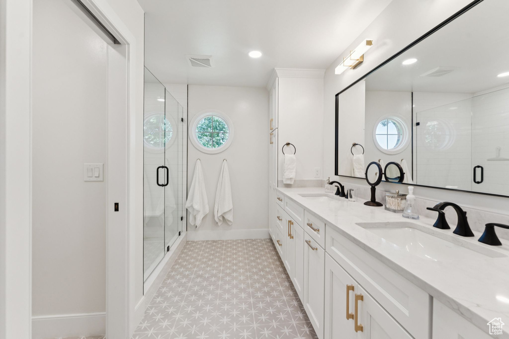 Full bath with tile patterned floors, double vanity, a shower stall, and recessed lighting