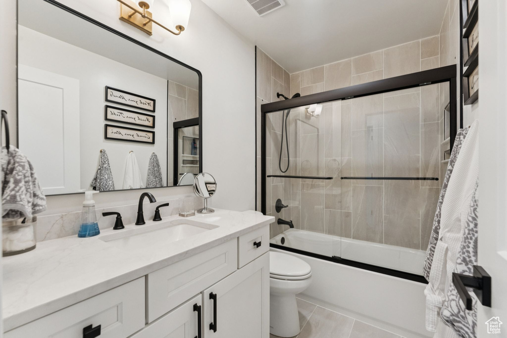 Bathroom with vanity and shower / bath combination with glass door