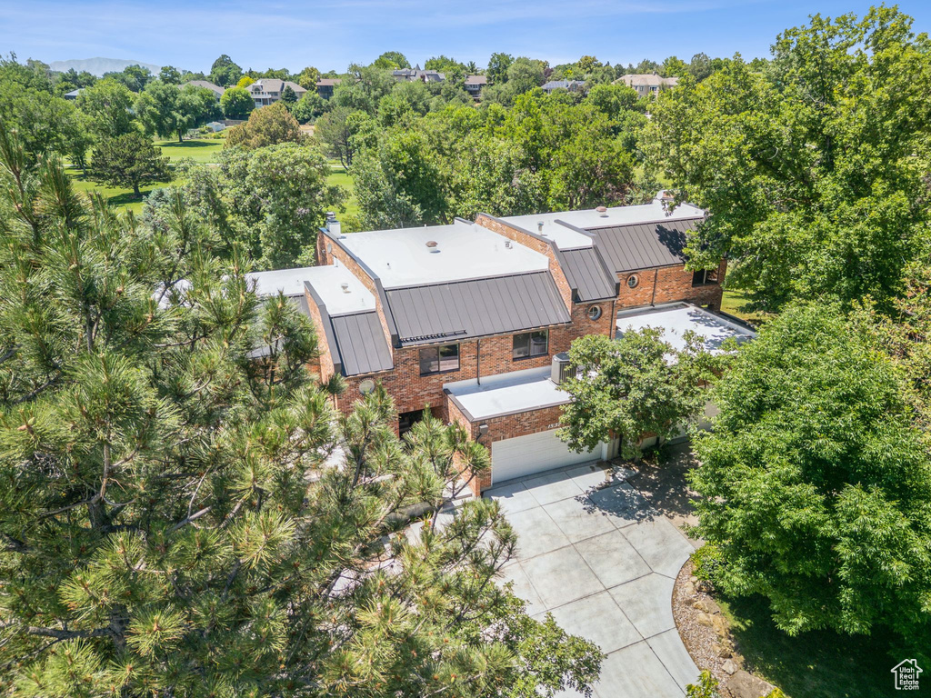 View from above of property featuring a tree filled landscape