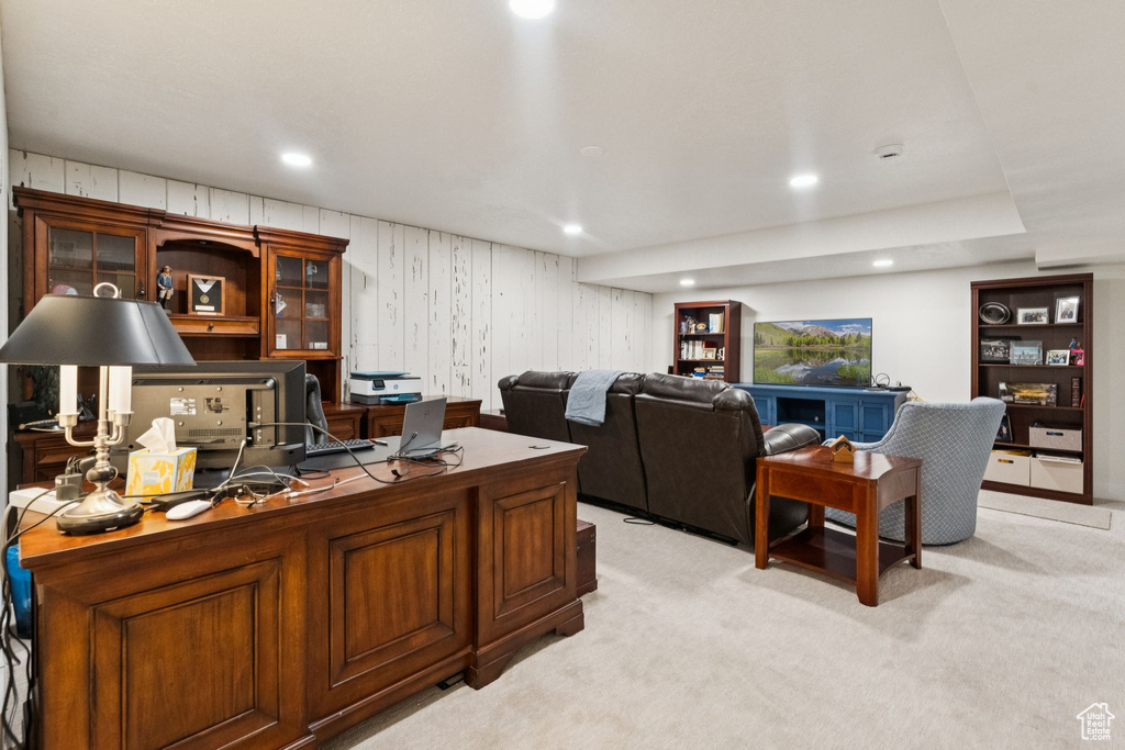 Office space with light carpet and recessed lighting