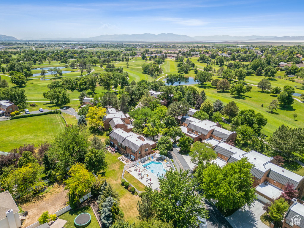 Aerial view of residential area featuring a water and mountain view and a golf club